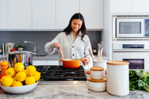 Lady cooking in kitchen at home