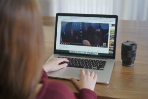 Lady looking at a video about a lens on a laptop