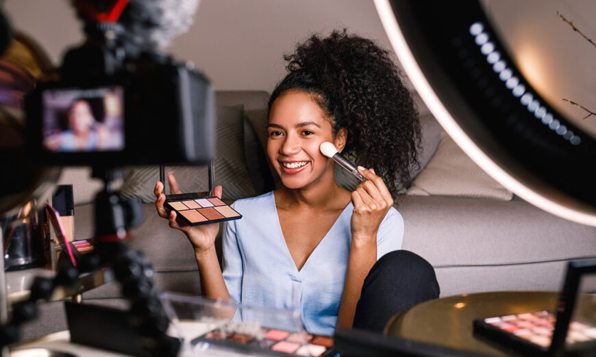 Girl shooting a makeup vlog with mirrorless and lighting