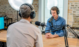 Two people with headphones on