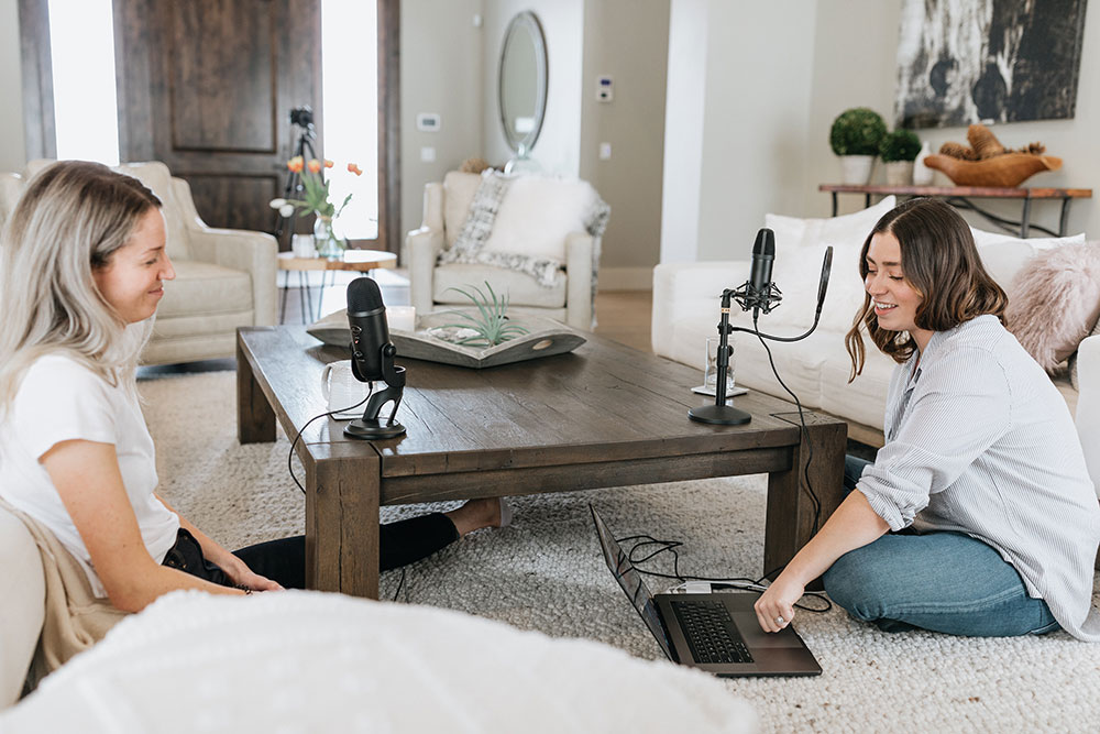 Two ladies sitting having a conversation during a podcast