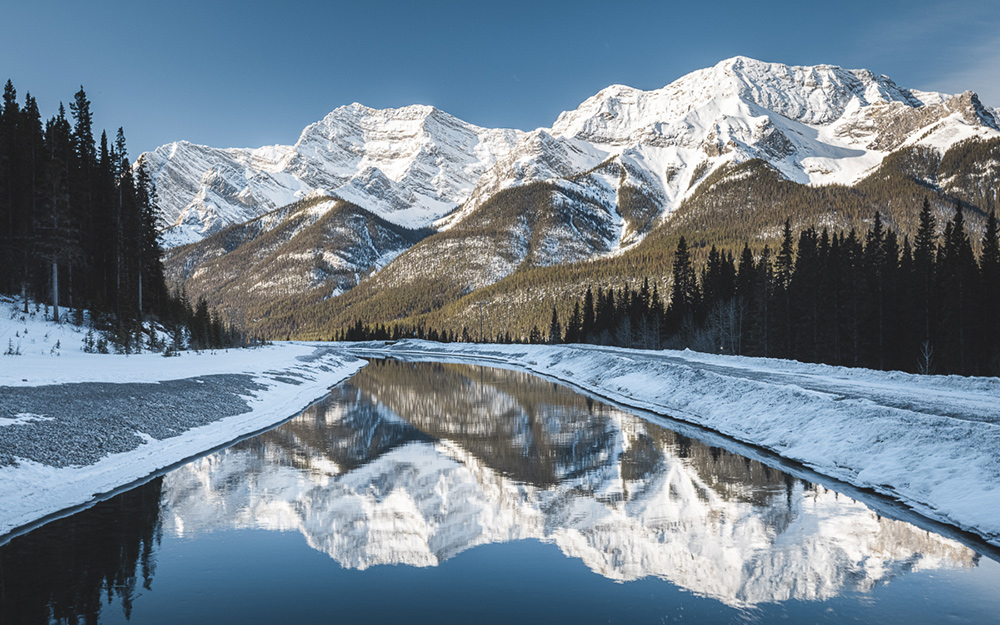 Reflections of distant mountains on a body of water