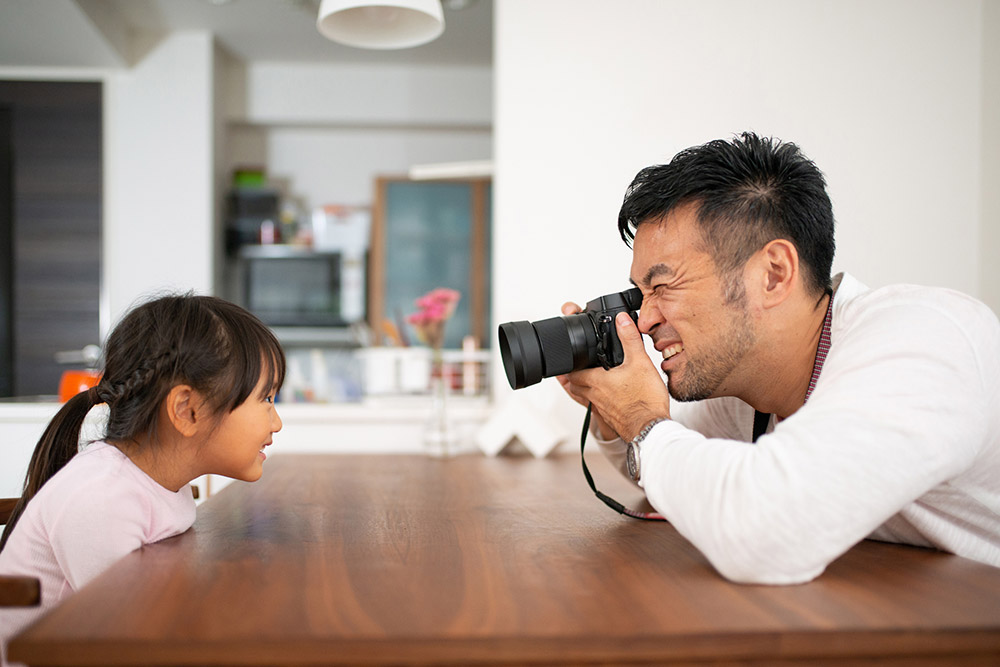 father-taking-photo-of-daughter