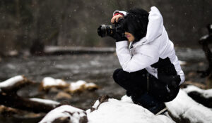 Girl Photographing Outside while Snowing
