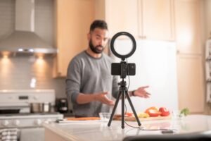 Man making a video of himself cooking