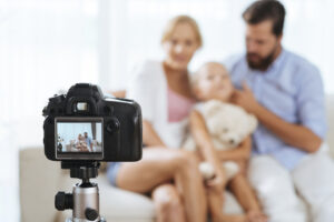 Parents With Child Sitting On A Couch For A Portrait Photo