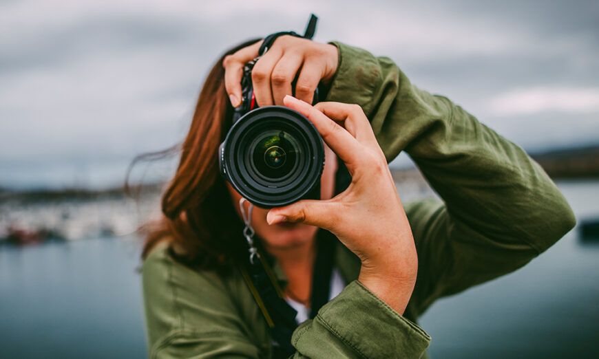 Female holding camera taking a photograph