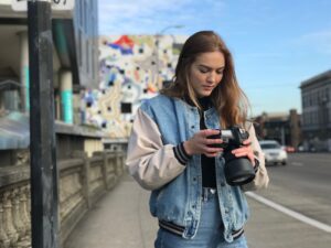 young female photographer standing outside